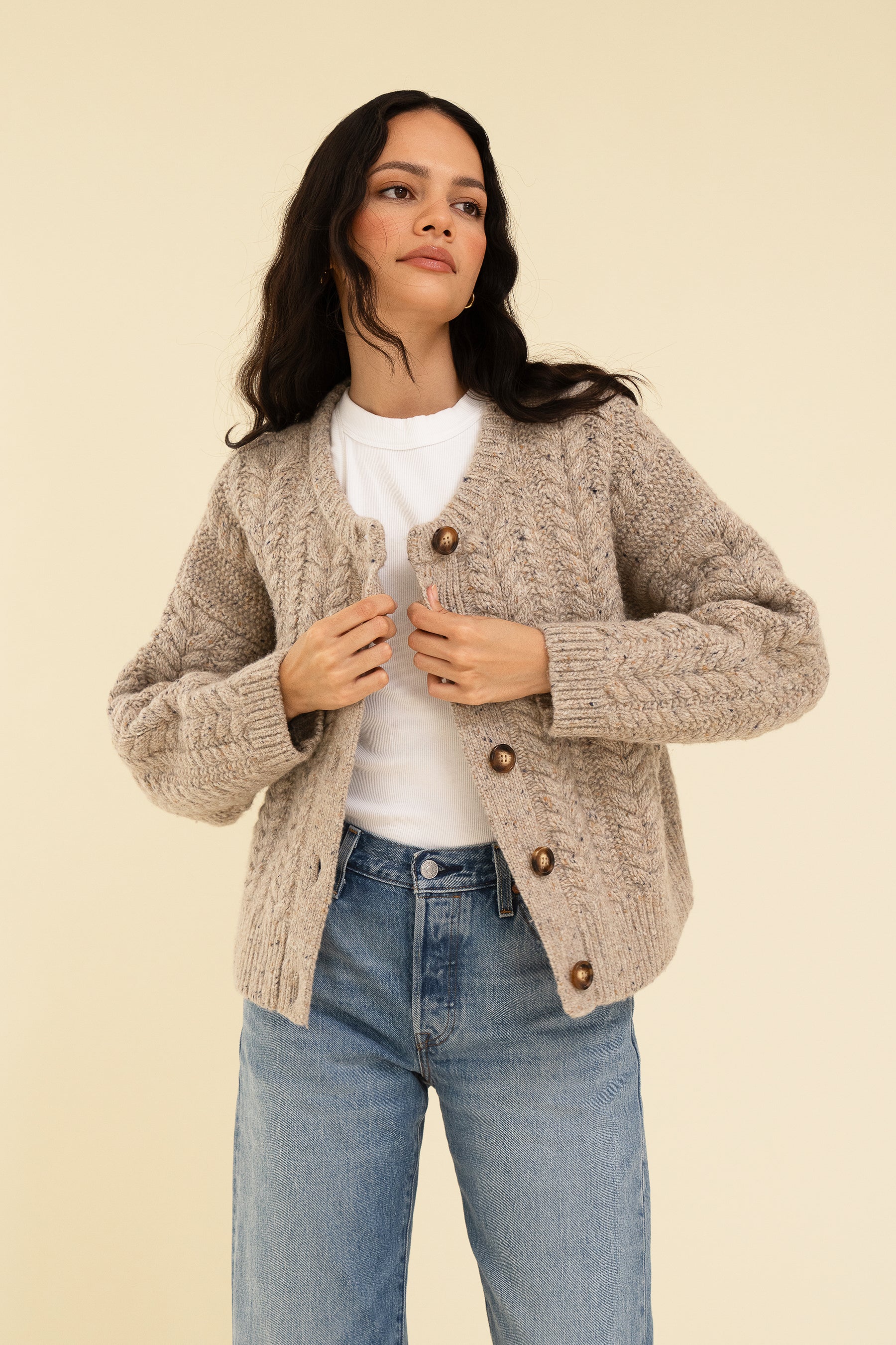 Sisterhood Sloan cardigan in oat, made from RWS Merino wool, recycled Nylon and Alpaca for the highest quality knit. Wear her fully buttoned or over a fresh white tee for a clean fit with your favourite jeans. Model wears size S and is 5'9.
